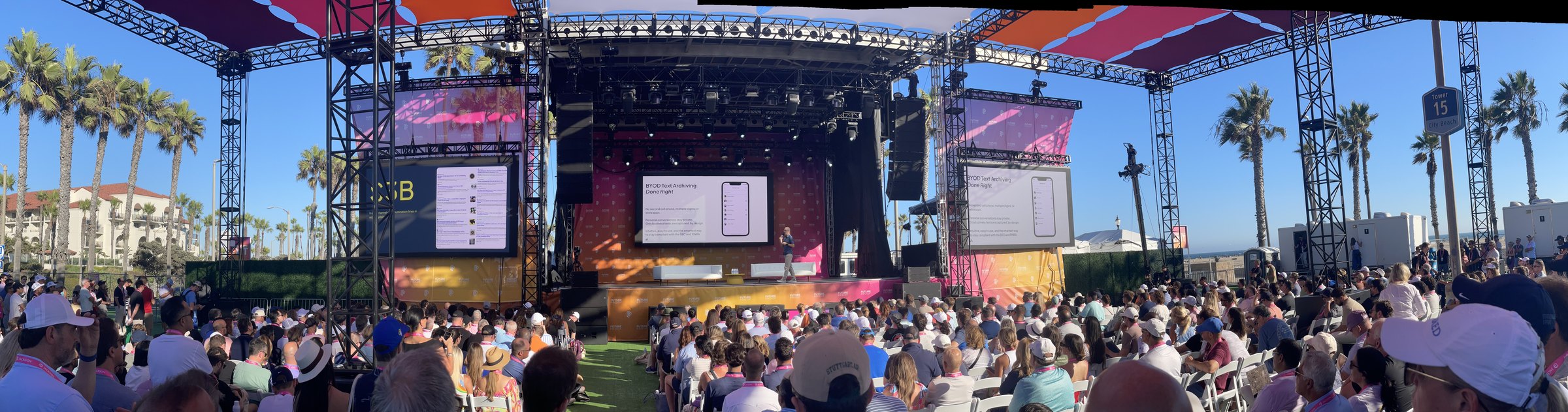 Panoramic view of the Future Proof Festival main stage in Huntington Beach, with Larry Shumbres presenting Archive Intel to a seated crowd
